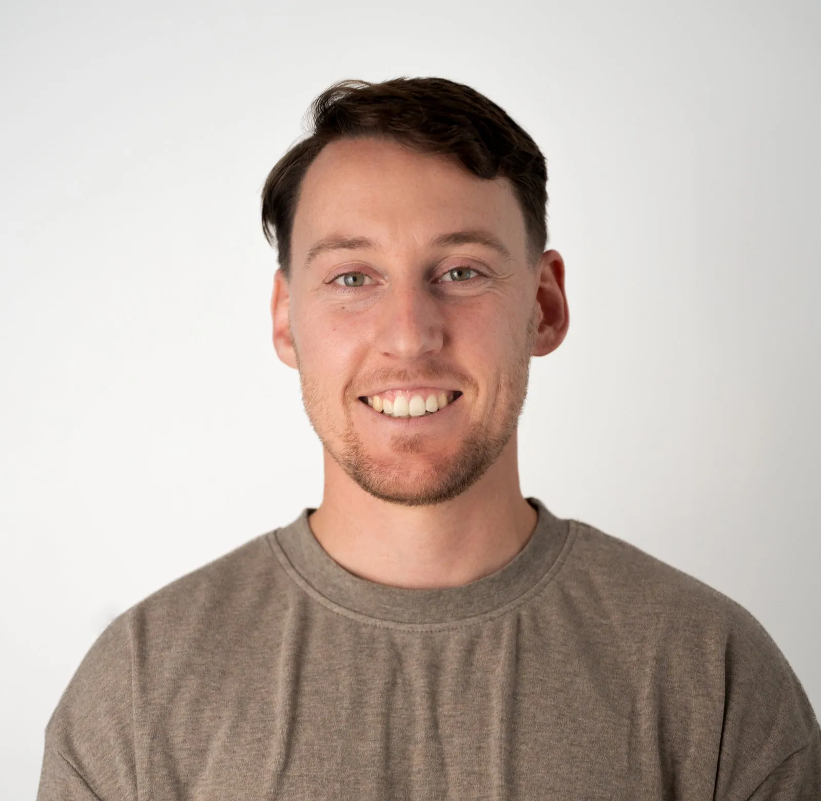 Keegan Baldwin, chiropractor, smiling against a plain light background